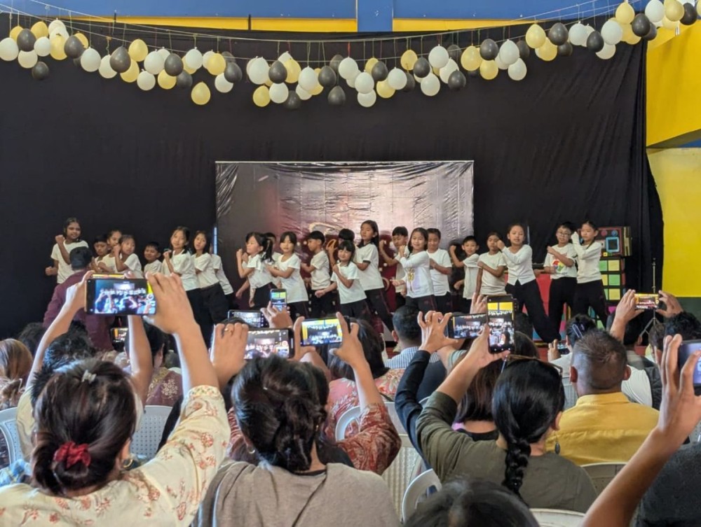 Parents recording videos and taking pictures as their children take center stage during a talent presentation event at Hope Academy New Campus, Naga United Village, Chümoukedima on November 27. (Morung Photo)